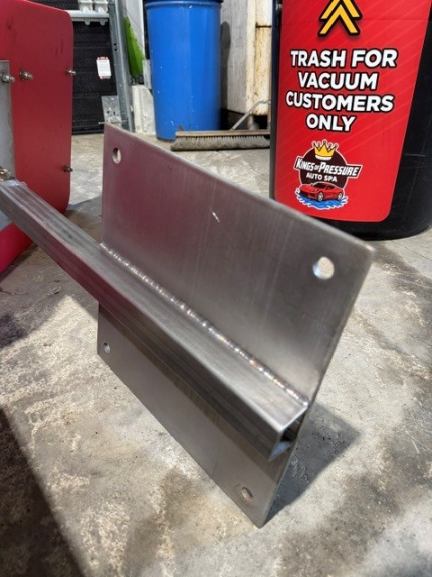 Stainless steel angled mounting bracket with a stacked-dime TIG weld bead