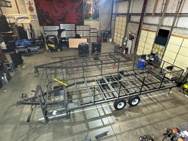 Custom-built tandem axle steel trailer frame under construction in the shop