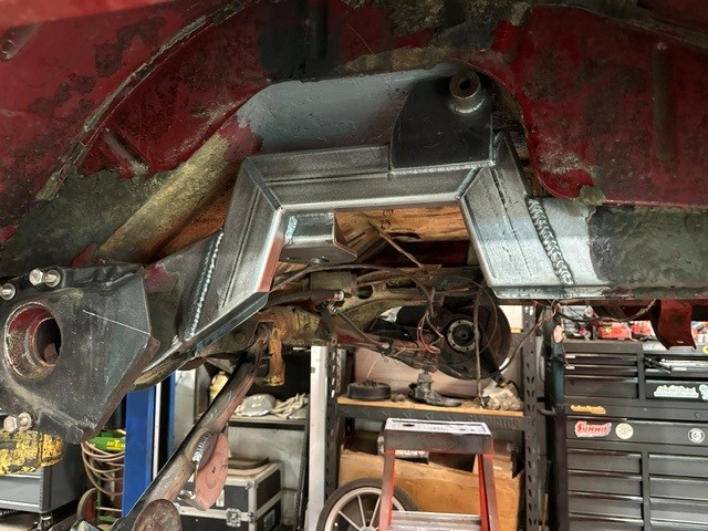 Freshly welded steel frame notch and suspension brackets on a vehicle chassis