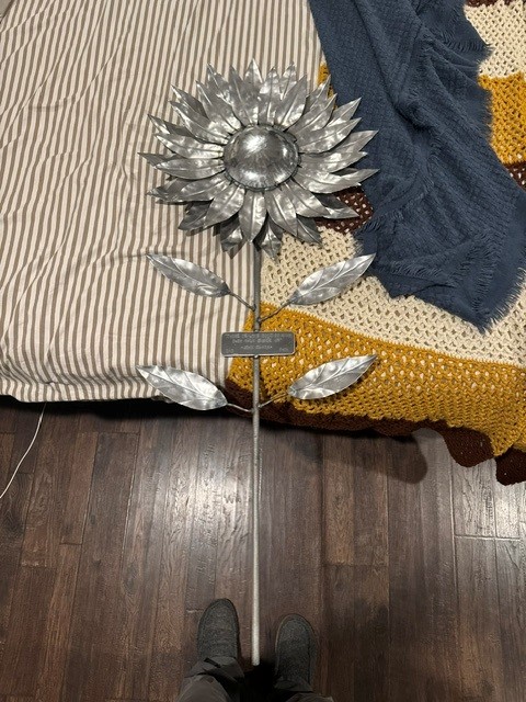 Hand-fabricated steel sunflower sculpture with engraved plaque on the stem