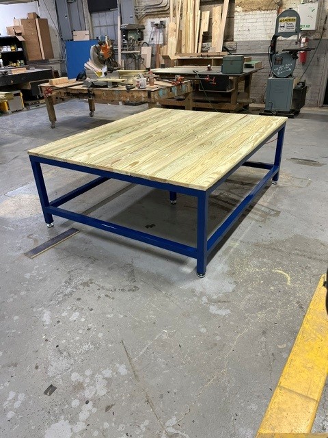 Blue powder-coated steel platform frame with a pressure-treated wood deck on casters